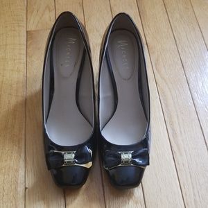 Black vinyl shoes with a cute bow detail